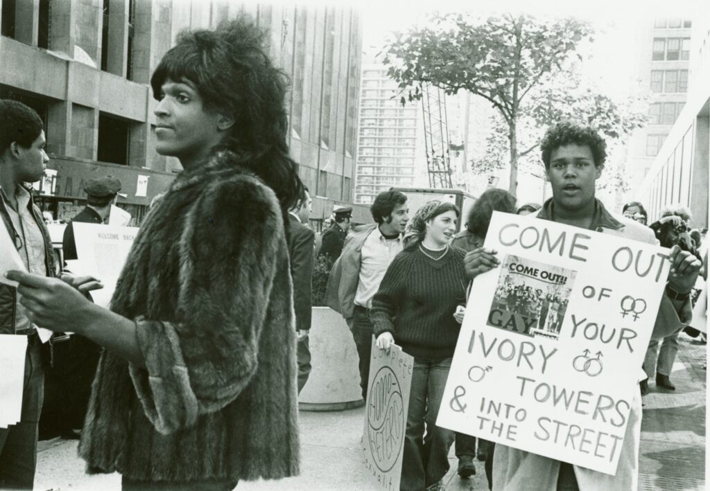 Marsha P. Johnson, Black trans activist founder of S.T.A.R. and the Gay Liberation Front, handing out flyers to students in support of gay rights.